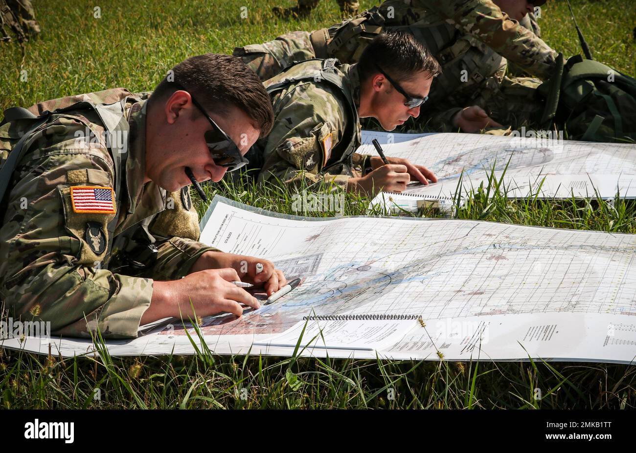 U.S. Army Soldiers make measurements using terrain maps during an air drop and sling load exercise as part of a U.S. Pathfinder course at Camp Dodge in Johnston, Iowa, on Sept. 8, 2022. Nearly 30 Soldiers graduated the course, which was taught by a mobile training team at the Army National Guard Warrior Training Center in Fort Benning, Georgia. Army Pathfinders are trained to provide navigational aid and advisory services to military aircraft in areas designated by supported unit commanders. During the Pathfinder course, students are instructed in aircraft orientation, aero-medical evacuation, Stock Photo