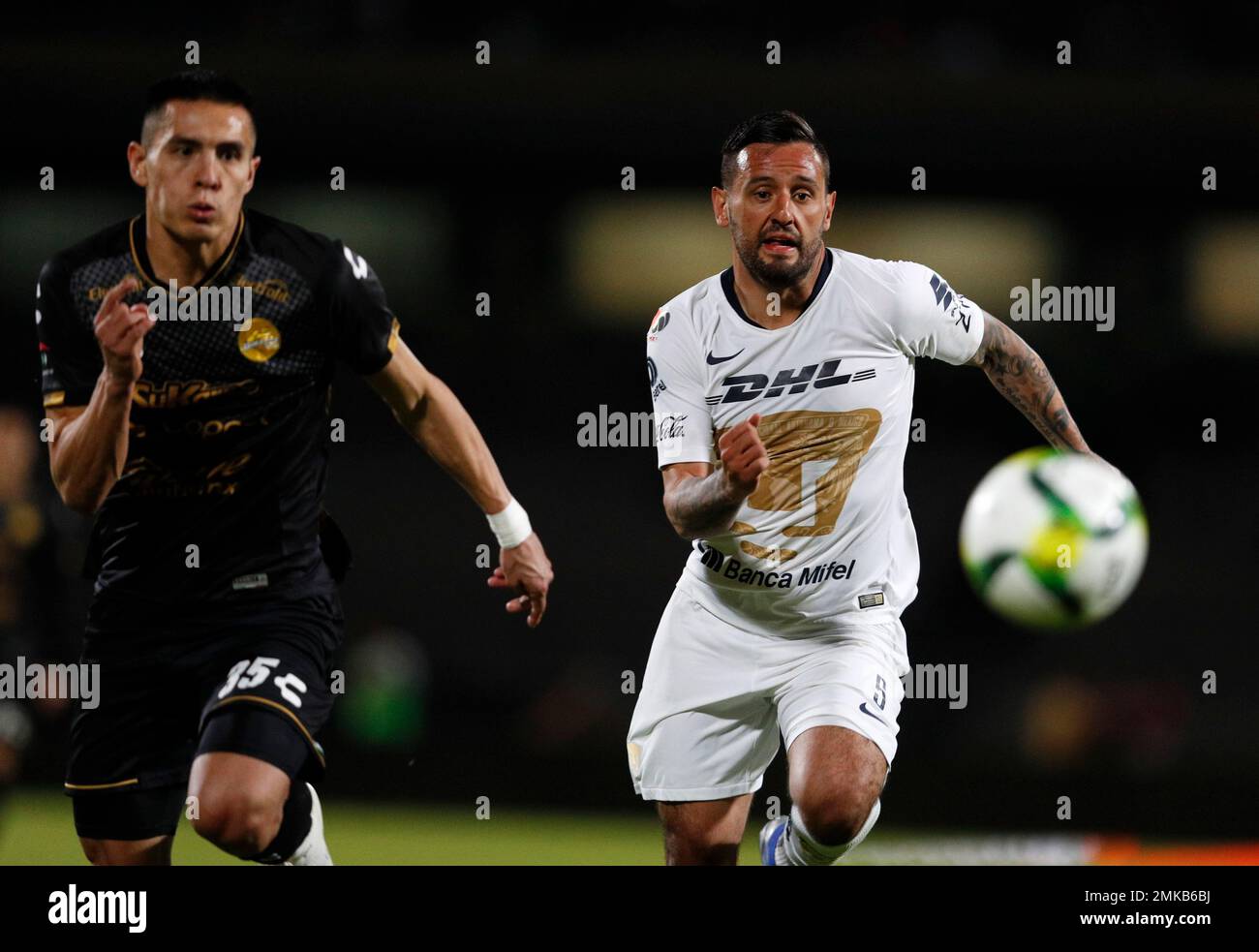 Pumas' Alan Mendoza, right, competes with Dorado's Rubio Mendez-Rubin in  their Copa MX quarterfinal match at Olympic University Stadium in Mexico  City, Tuesday, March 12, 2019. (AP Photo/Rebecca Blackwell Stock Photo -
