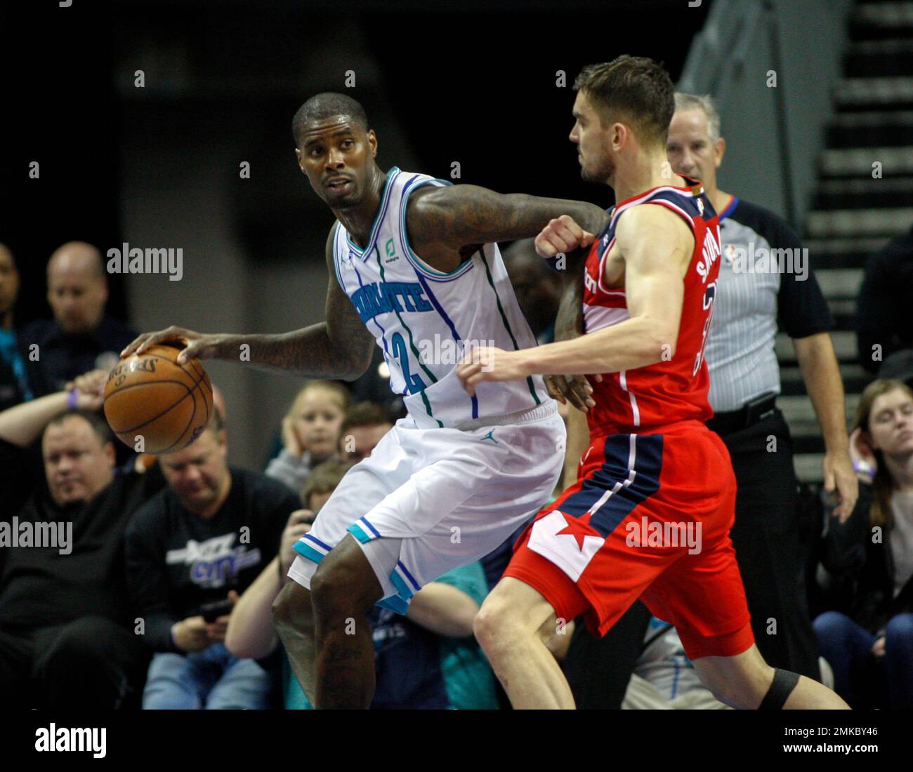 Charlotte Hornets forward Marvin Williams, left, drives into Washington ...