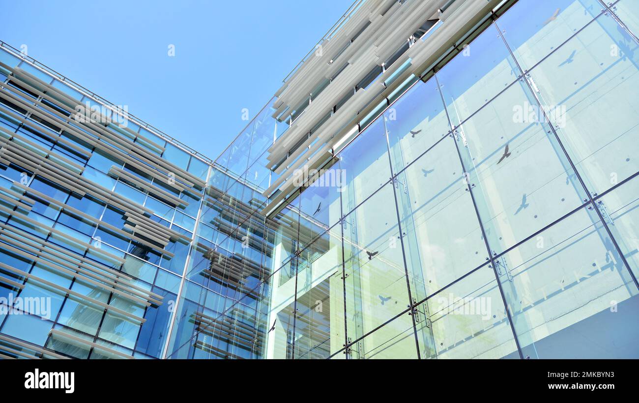 Abstract closeup of the glass-clad facade of a modern building covered ...