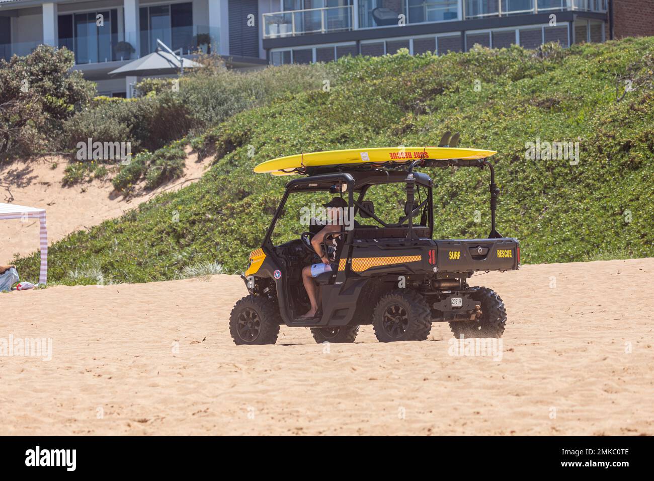 Australian surf rescue volunteer driving surf rescue beach buggy car