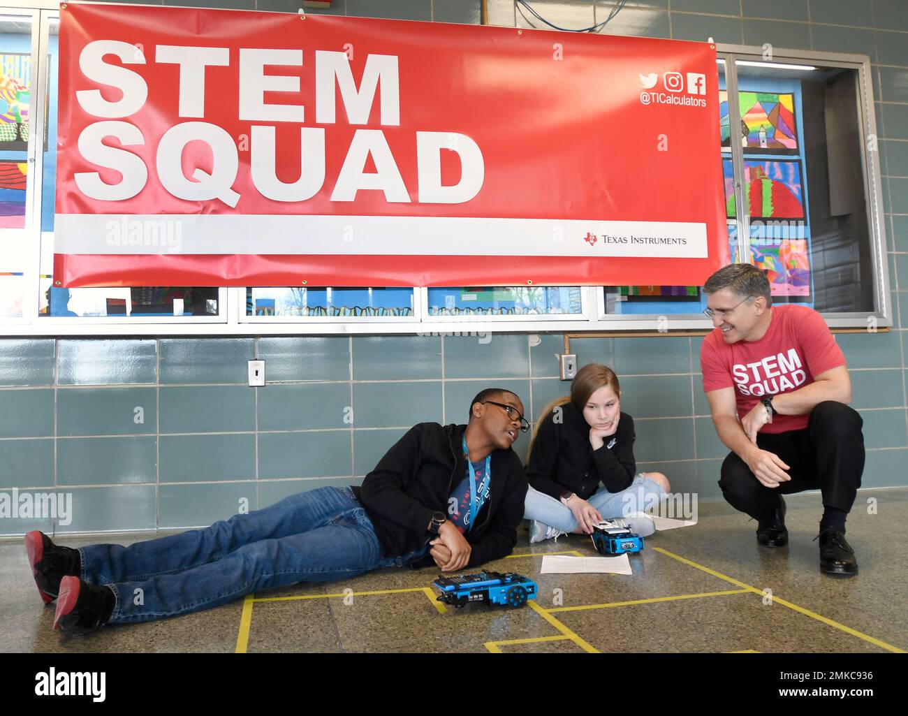 IMAGE DISTRIBUTED FOR TEXAS INSTRUMENTS - Peter Balyta, right, president of Texas  Instruments Education Technology, works with Parkville Middle School  seventh-graders Joshua Jones, left, and Madilynn Wiatrowski, to program  robotic cars with