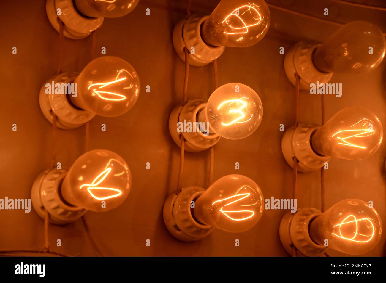 Old style lightbulbs glowing with the filaments lit on a panel Stock ...