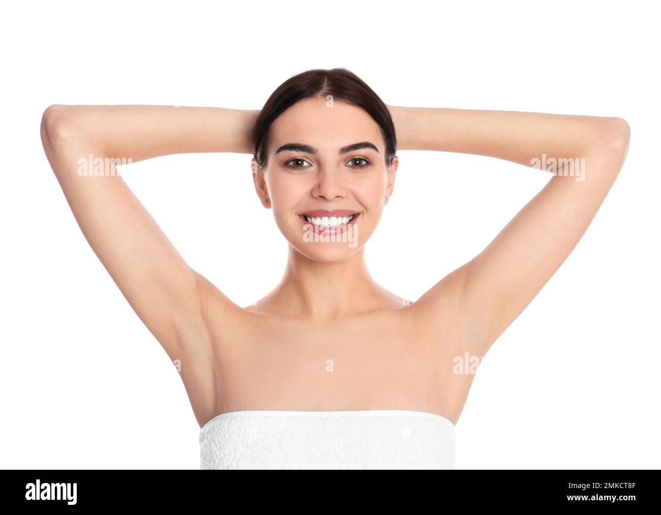 Young woman showing hairless armpits after epilation procedure on white