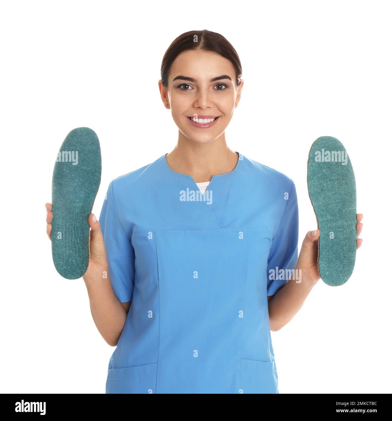 Female orthopedist showing insoles on white background Stock Photo - Alamy