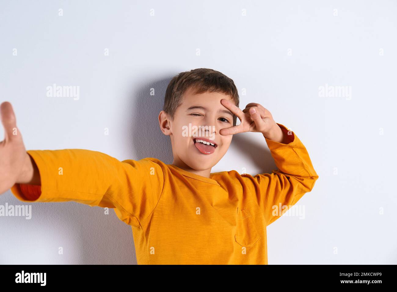 Portrait of cute little boy on light background Stock Photo
