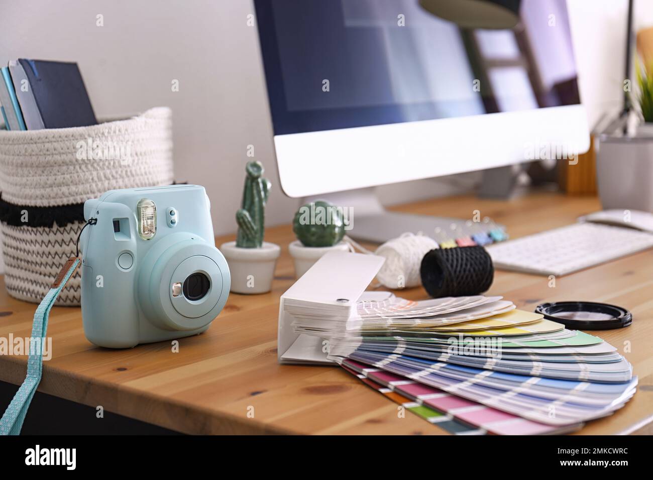 Digital camera and color palette on table in studio. Modern designer's ...