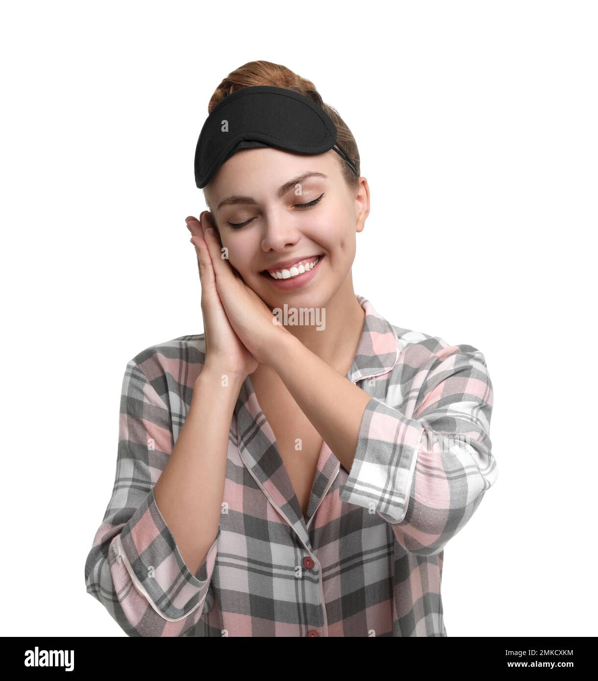 Beautiful woman wearing pajamas and sleeping mask on white background