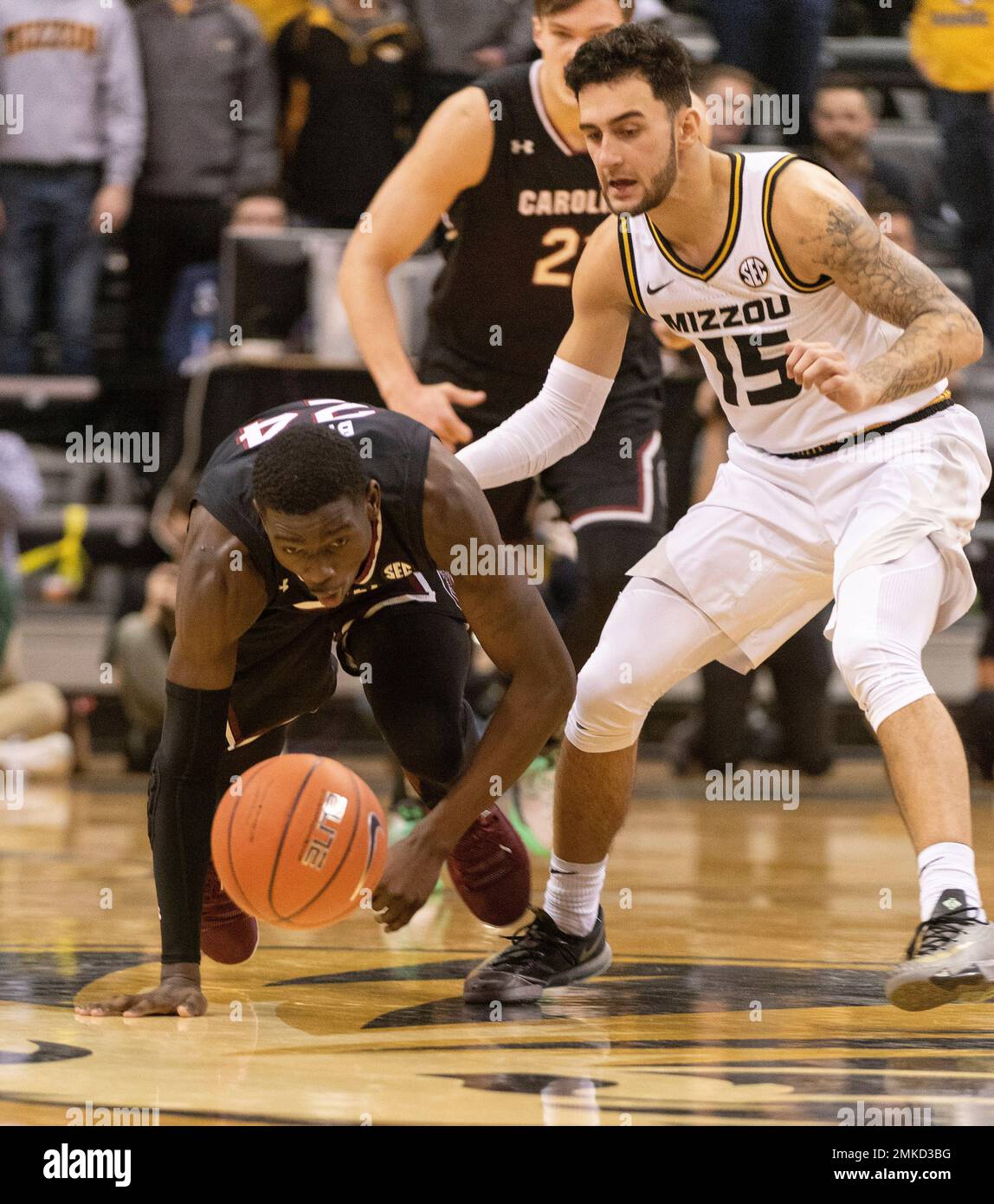 South Carolina's Keyshawn Bryant, left, and Missouri's Jordan Geist, right,  scramble for a loose ball during the first half of an NCAA college  basketball game Saturday, March 2, 2019, in Columbia, Mo. (