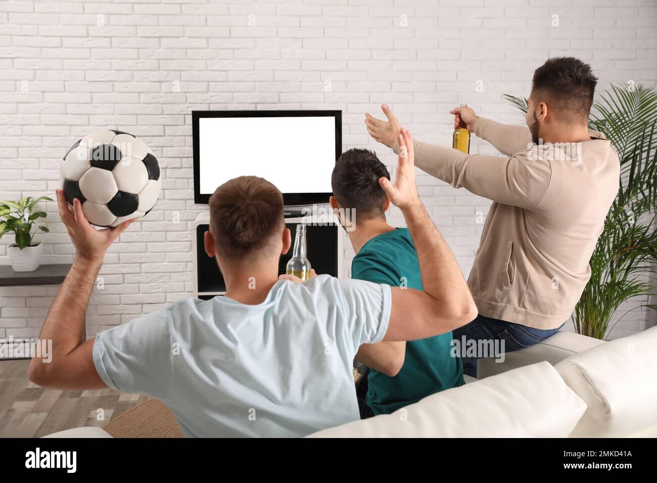 Group of friends watching football at home, back view Stock Photo Alamy