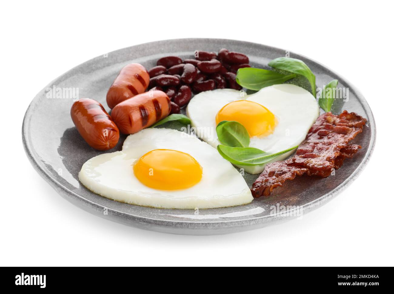 Plate of tasty breakfast with heart shaped fried eggs isolated on white ...