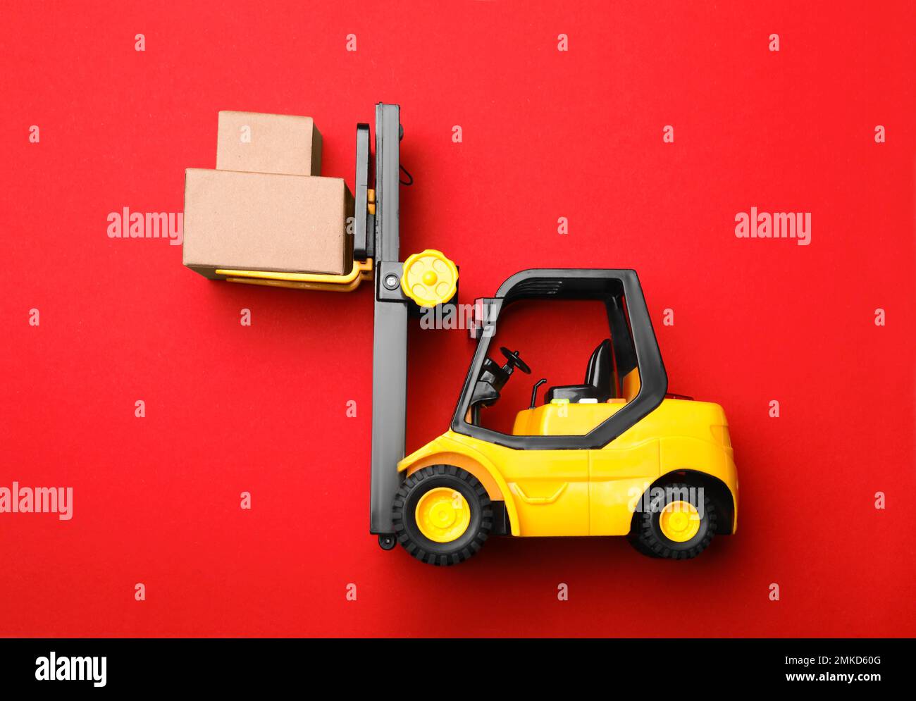 Top view of toy forklift with boxes on red background. Logistics and  wholesale concept Stock Photo - Alamy