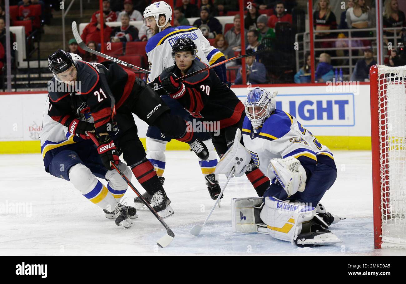 Carolina Hurricanes' Nino Niederreiter (21) and Sebastian Aho try to