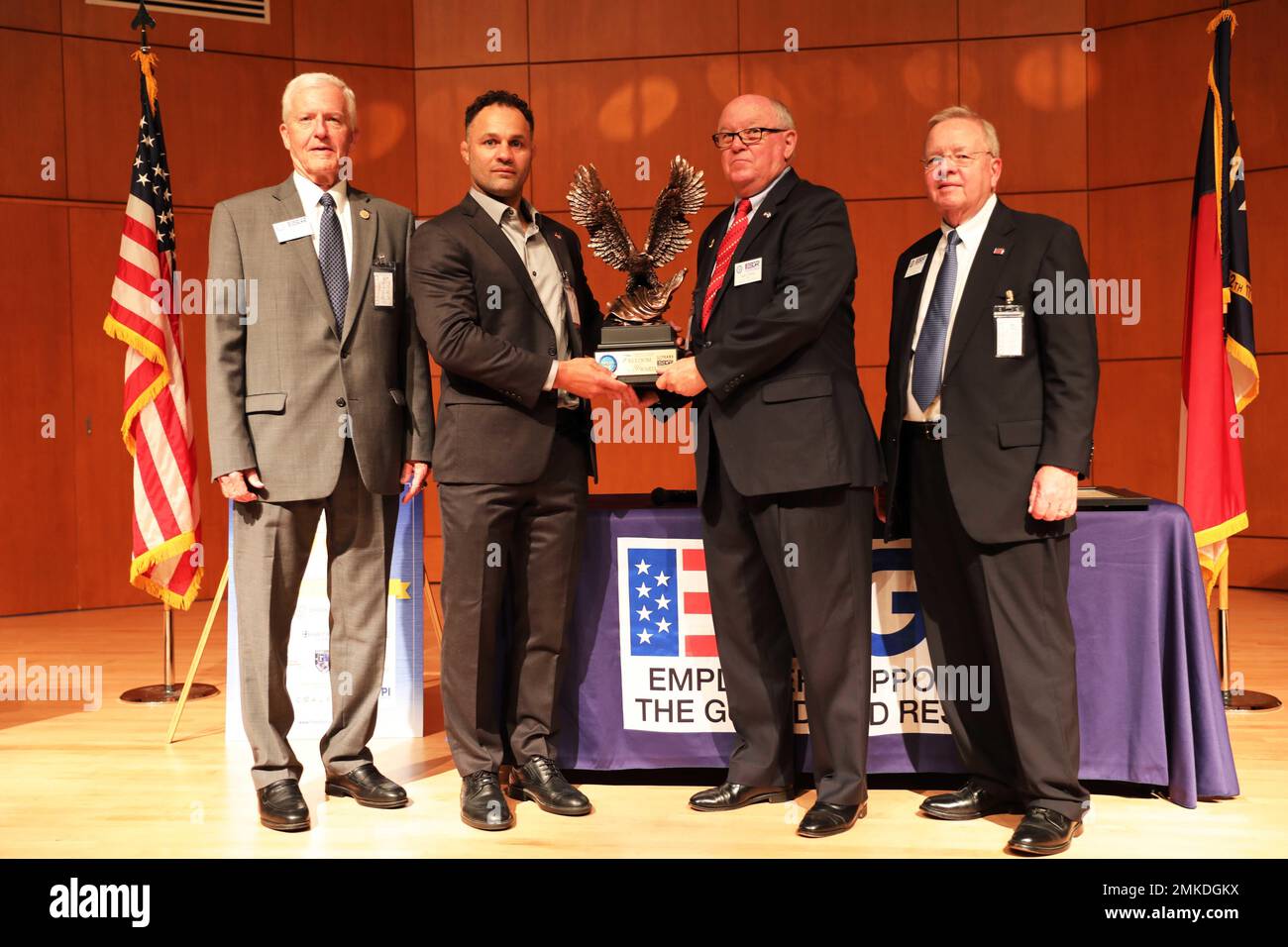 Iwan Clontz (center right), North Carolina Employer Support of the Guard and Reserve State Chairman, Ron Bogle (far left), ESGR National Chairman, and Ed Hamilton (far right), NC-ESGR Vice Chairman, congratulate Josh Koshcheck (Center left), Chief Executive Officer of Check Defense and recipient of the Secretary of Defense Freedom Award, during a ceremony at Joint Forces Headquarters, Raleigh, North Carolina, Sept. 8, 2022. The Freedom Award is the highest recognition given by the United States Government to employers for their outstanding support of employees serving in the Guard and Reserve. Stock Photo