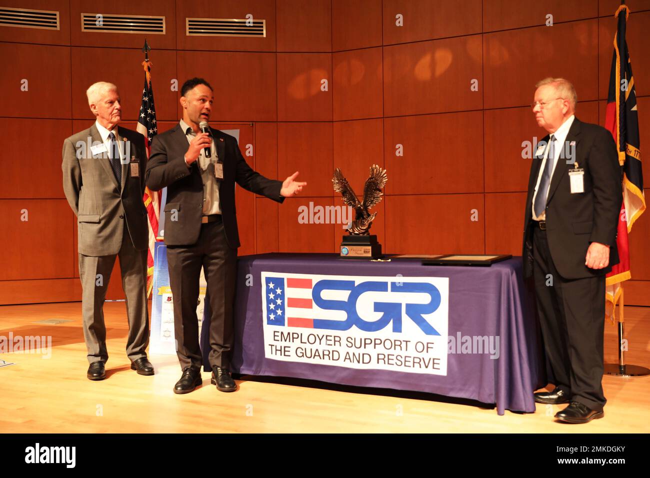 Josh Koshcheck (Center left), Chief Executive Officer of Check Defense and recipient of the Secretary of Defense Freedom Award, thanks Ron Bogle (far right), Employer Support of the Guard and Reserve National Chairman, and Ed Hamilton (far left), NC-ESGR Vice Chairman, during a ceremony at the North Carolina National Guard's Joint Forces Headquarter, Raleigh, North Carolina, Sept. 8, 2022. The Freedom Award is the highest recognition given by the United States Government to employers for their outstanding support of employees serving in the Guard and Reserve. Stock Photo