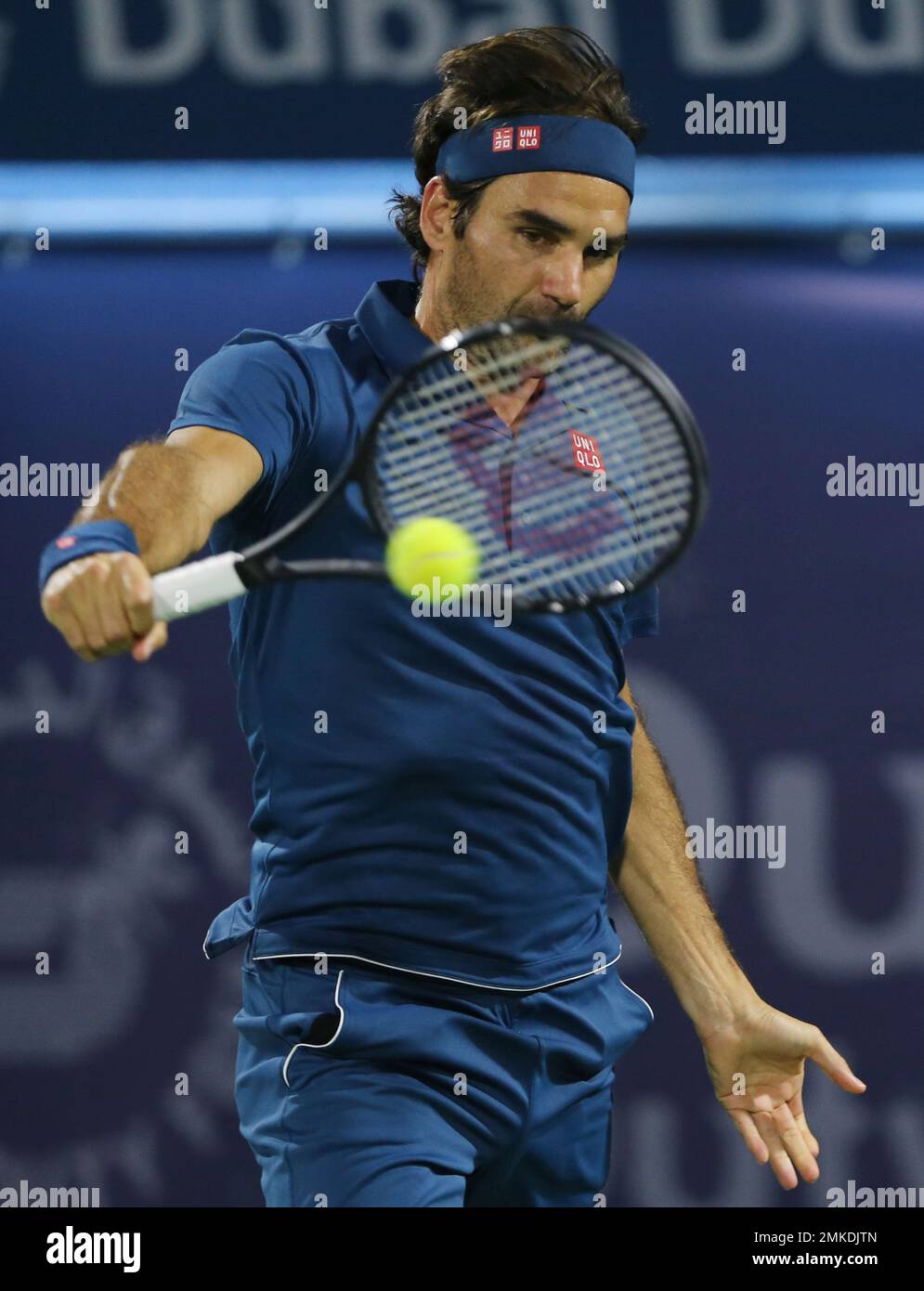 Roger Federer of Switzerland returns the ball to Marton Fucsovics of Hungry during their match at the Dubai Duty Free Tennis Championship, in Dubai, United Arab Emirates, Thursday, Feb