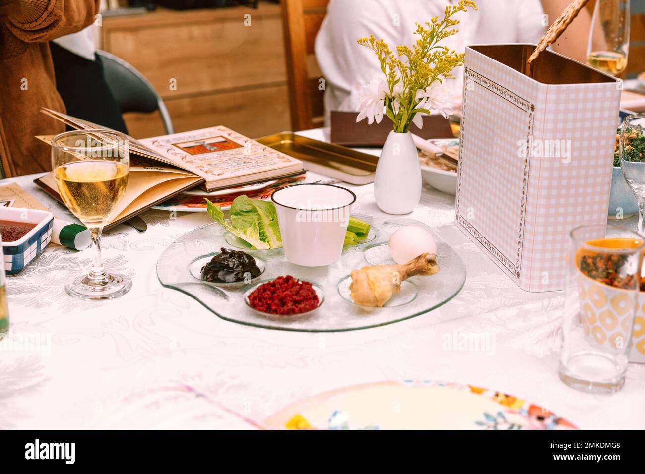 Passover table setting with a traditional Passover seder plate with symbolic meal, matzah, and