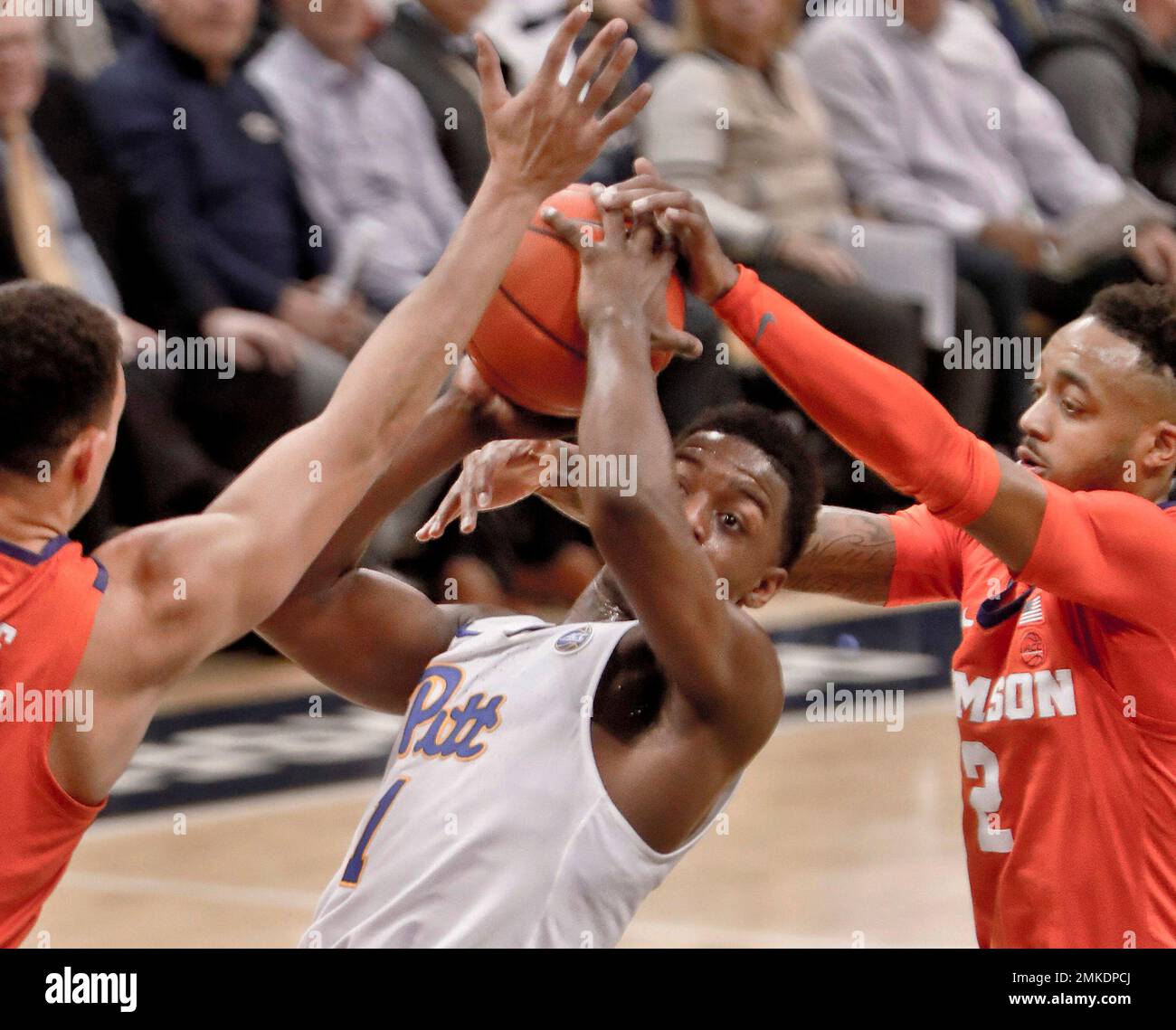 Clemson's Javan White, left, and Marcquise Reed, right, block a shot by ...