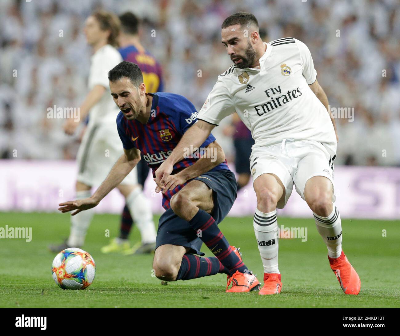 Barcelona midfielder Sergio Busquets heads the ball over AC Milan  midfielder Kevin Prince Boateng, of Ghana, during a Champions League first  leg quarterfinals soccer match, between AC Milan and Barcelona, at the