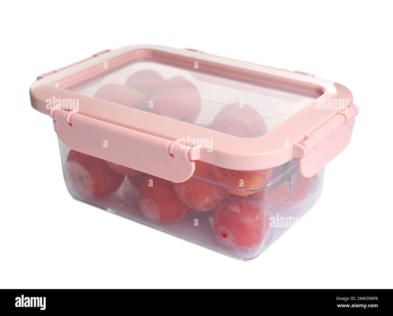 Frozen tomatoes in plastic container isolated on white. Vegetable preservation Stock Photo