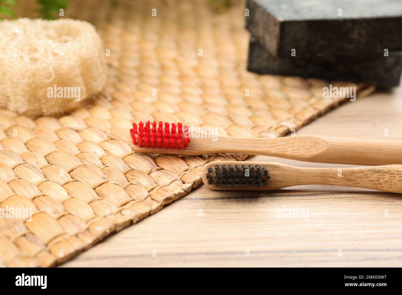 Natural toothbrushes made with bamboo on wooden table Stock Photo