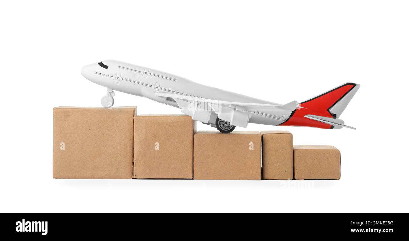 Toy plane with boxes isolated on white. Logistics and wholesale concept