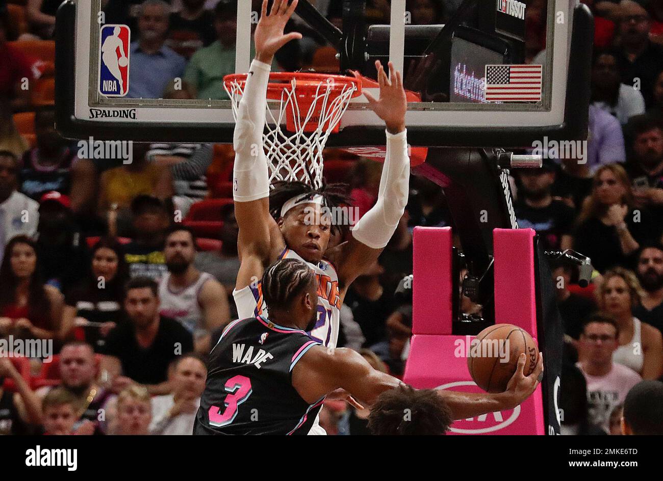 Miami Heat guard Dwyane Wade (3) scores against Phoenix Suns forward  Richaun Holmes (21) during the first half of an NBA basketball game Monday,  Feb. 25, 2019, in Miami. (AP Photo/Brynn Anderson