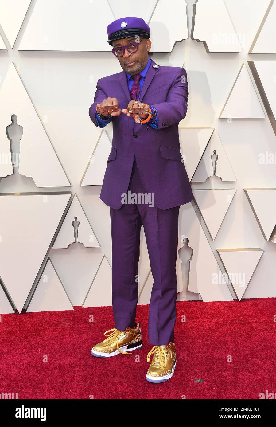 Spike Lee holds up brass knuckles reading 