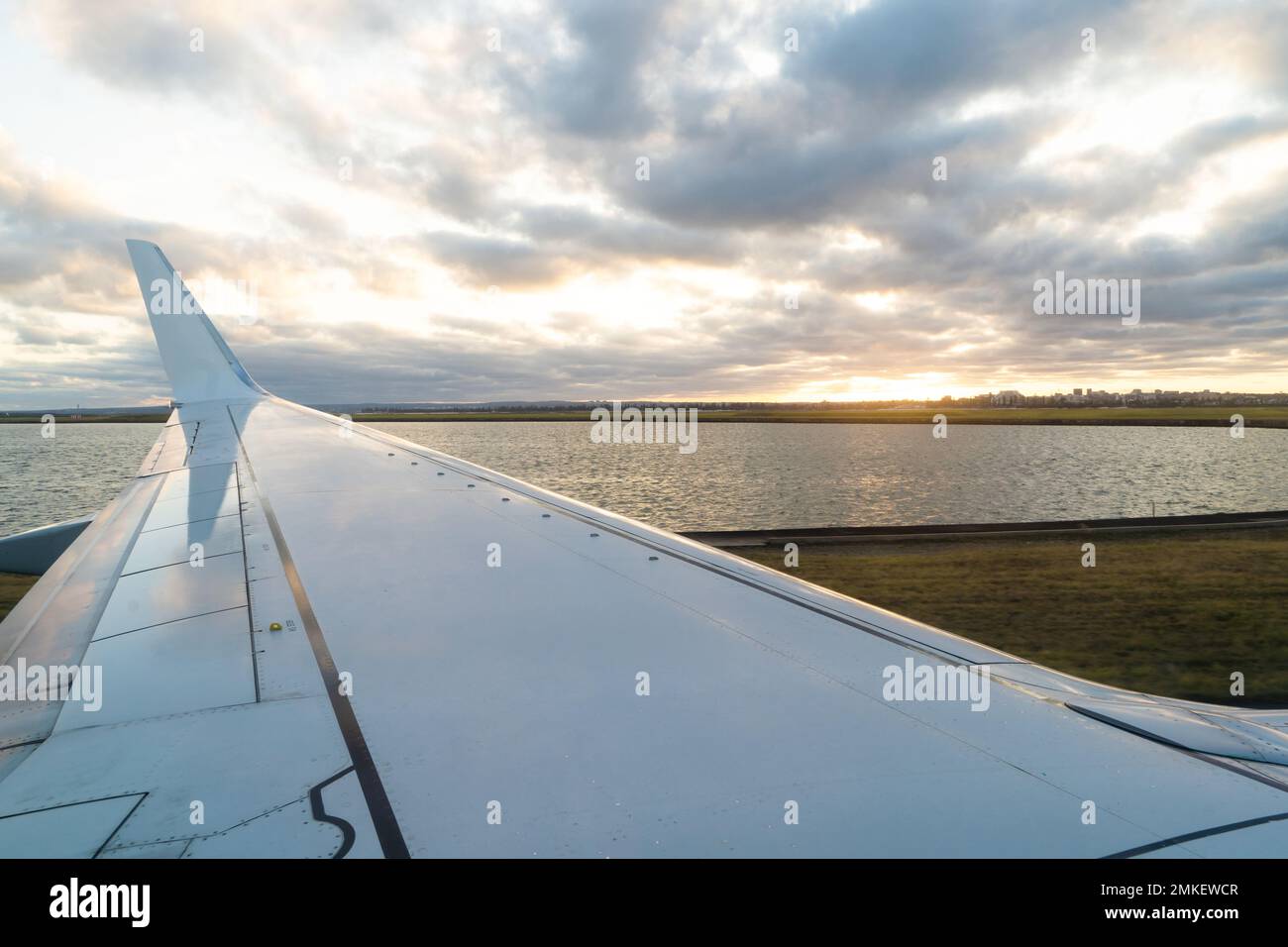 View of a Landing Airplane Wing from Window Seat Stock Photo
