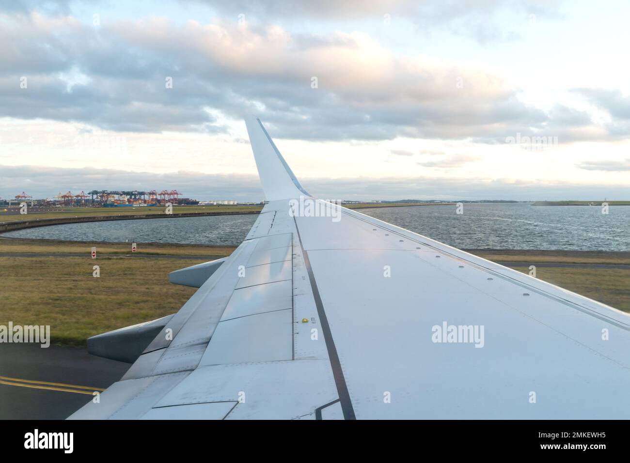 View of a Landing Airplane Wing from Window Seat Stock Photo