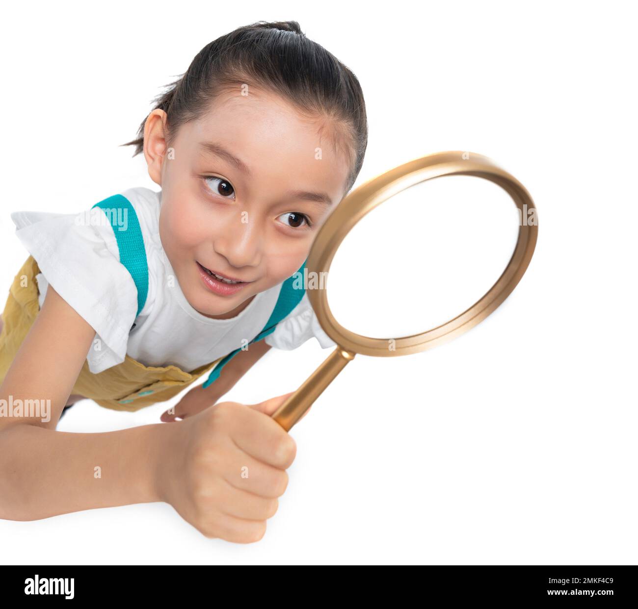 Happy girl with a magnifying glass Stock Photo - Alamy