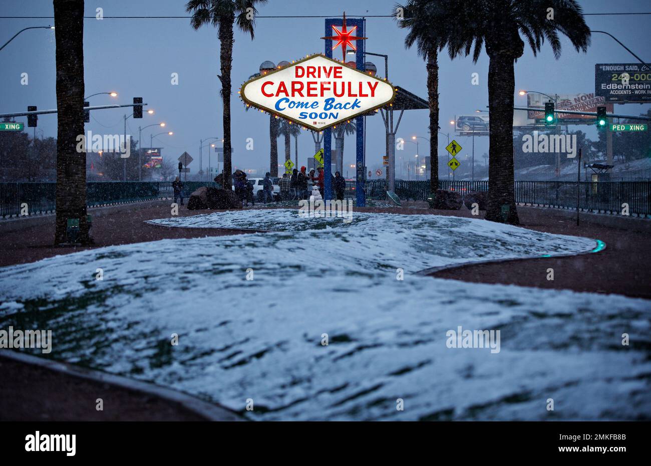 Snow accumulates on a median along the Las Vegas Strip at the "Welcome to  Fabulous Las Vegas" sign, Thursday, Feb. 21, 2019, in Las Vegas. Las Vegas  is getting a rare taste