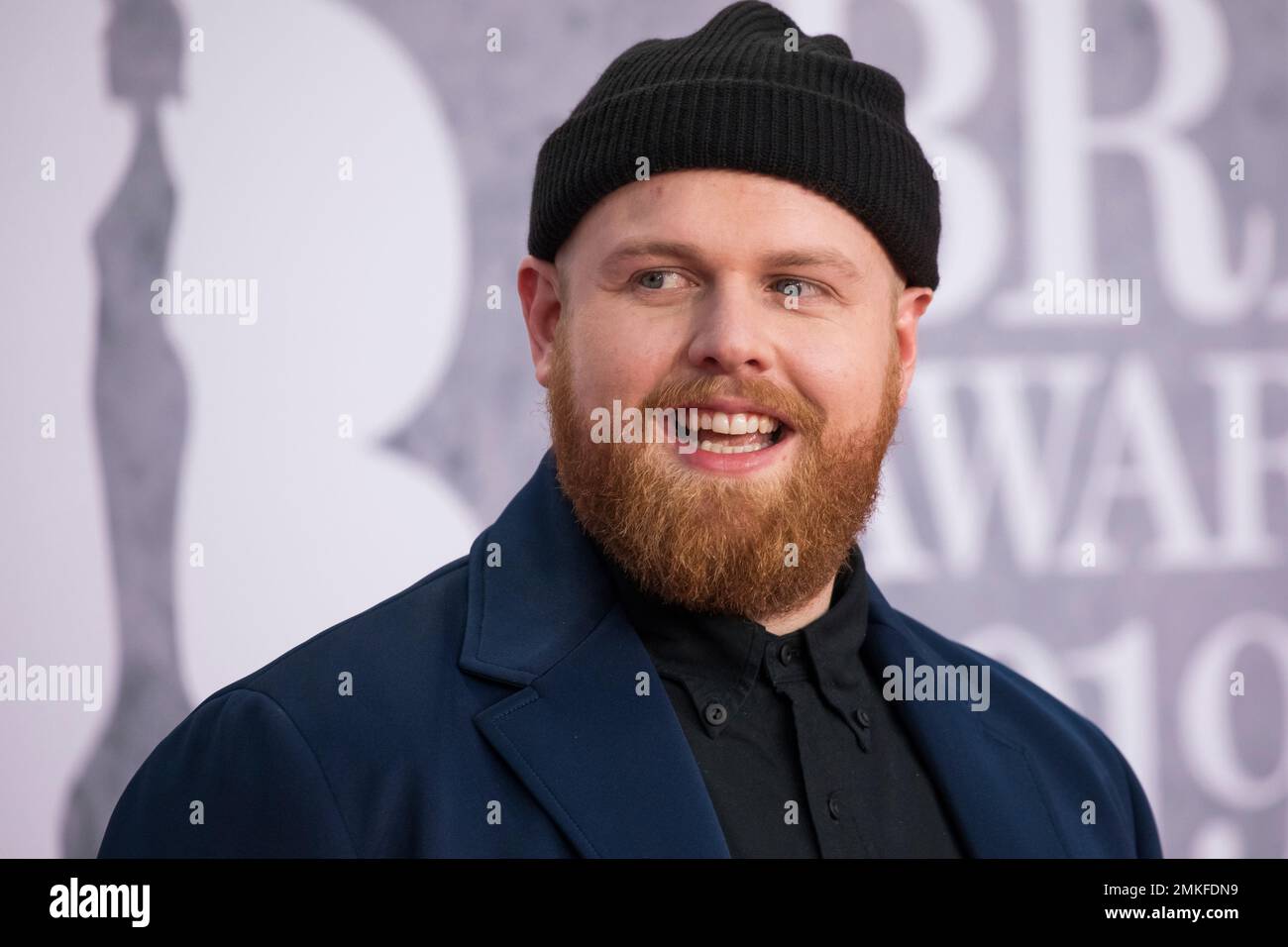 Tom Walker poses for photographers upon arrival at the Brit Awards in