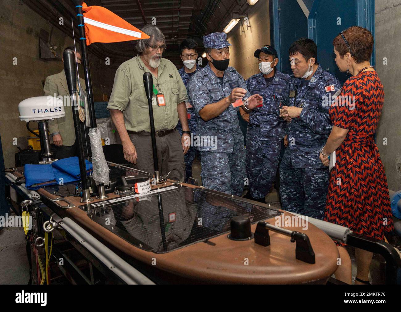 220908-N-FO714-1035  YOKOSUKA, Japan (Sept. 8, 2022) Mr. Barry Parker, Trident Research Secure Autonomous Datalink for Undersea Warfare (USW) Portable Range (SADL-UP) lead engineer, conducts familiarization training for Japan Maritime Self-Defense Force (JMSDF) sailors for an upcoming anti-submarine warfare bilateral training exercise at the Commander, Task Force 71 cave onboard Commander, Fleet Activities Yokosuka, Sept. 8. The U.S. Navy and JMSDF regularly fly, sail and operate together with other Allies and partners to promote security and stability throughout the region. Stock Photo