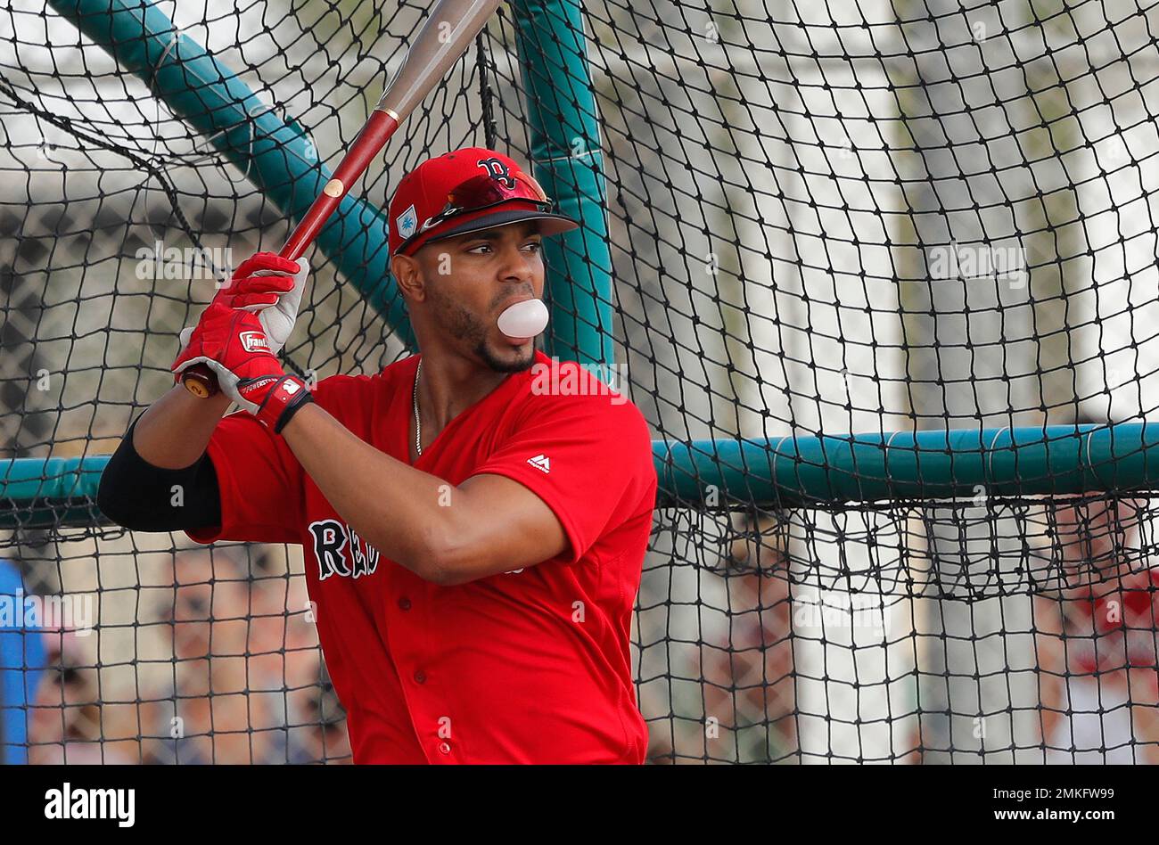 Boston Red Sox shortstop Xander Bogaerts blow a bubble in the batting cage, during their first