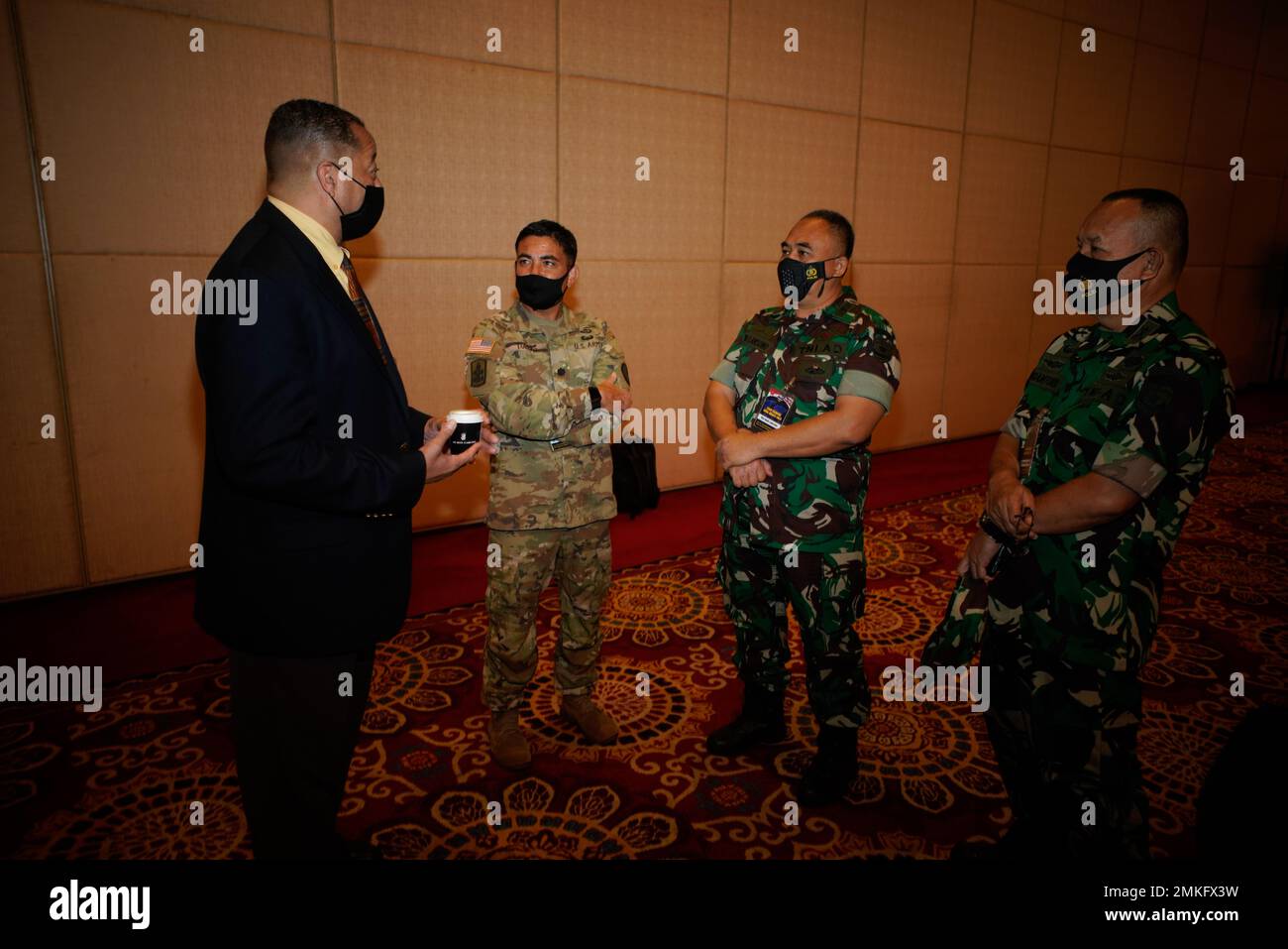 US Marine Lt. Col. (ret) Bernard Carey, USINDOPACOM, Exercise Control Group Senior Controller, and Army Lt. Col. Brandon Torres Hawaii Army National Guard their Tentara Nasional Indonesia (TNI, Indonesian Armed Forces) counterparts discuss the history of Gema Bhakti and the TNI’s development of the TNI Regional Defense Commands (KOGABWILHAN) on the first day for Gema Bhakti 2022, September 09, 2022, Jakarta Indonesia. Gema Bhakti 22 is a USINDOPACOM Joint Exercise Program event, utilizing US Joint forces partnering with TNI Armed Forces working together to increase interoperability and enhance Stock Photo