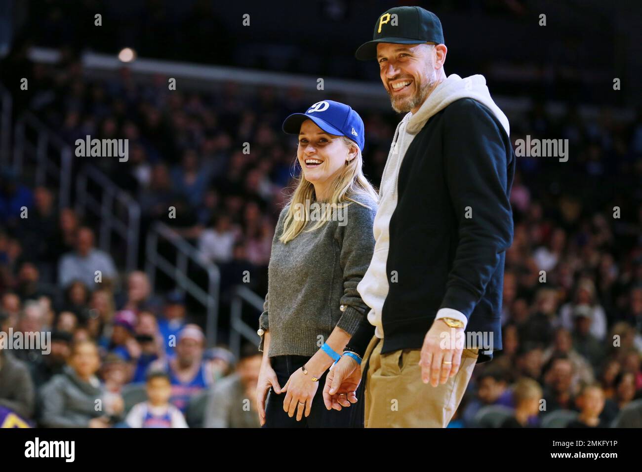 Reese Witherspoon and her husband Jim Toth attend The Harlem Globetrotters game at Staples Center on Feb. 17, 2019, in Los Angeles. (Photo by John Salangsang/Invision for The Harlem Globetrotters/AP) Stock Photo