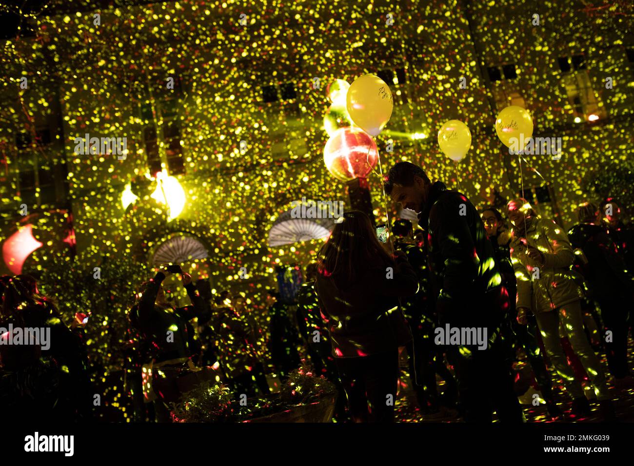 People watch and take photographs of a light installation during the Bright festival in Brussels