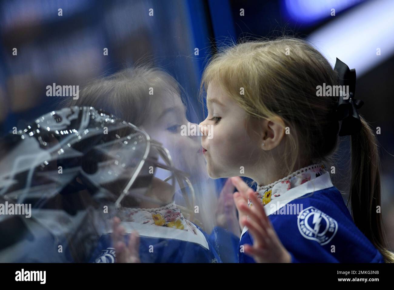 Mila Domingue, 2, kisses the glass as her father, Tampa Bay Lightning