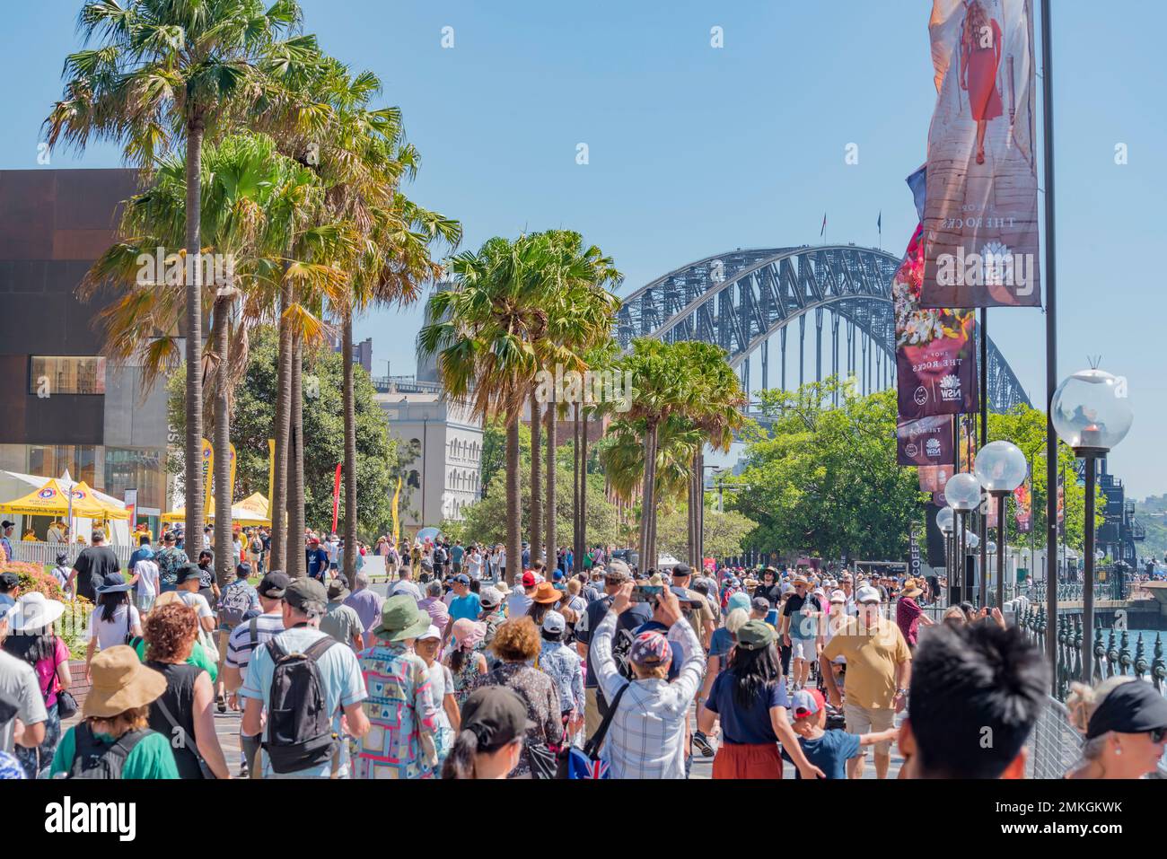 Crowds of people moving in Circular Quay with the Sydney Harbour Bridge in the background, on Australia Day January 26th, 2023 Stock Photo
