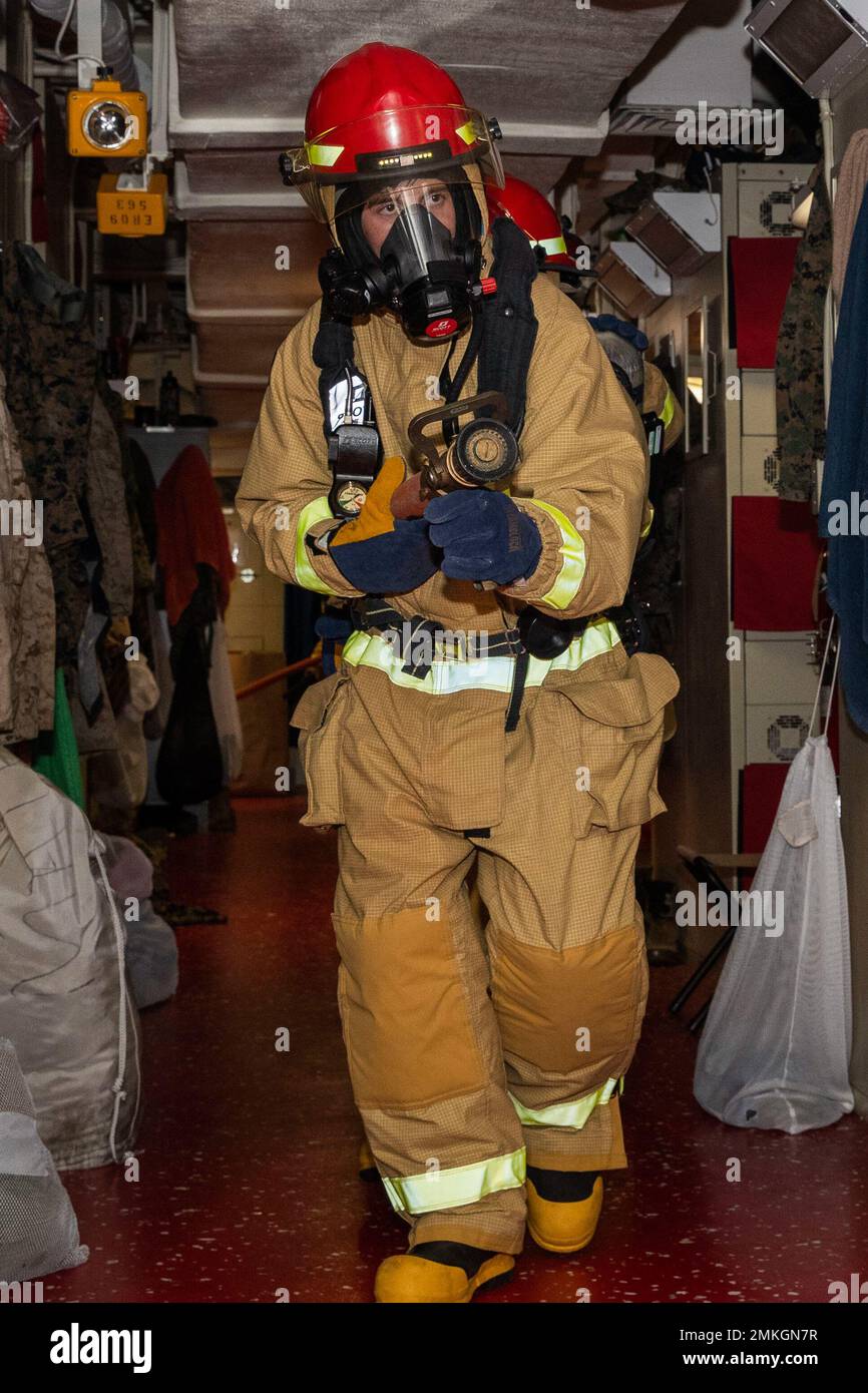 220910-N-CM110-1036 SOUTH CHINA SEA (Sept. 10, 2022) – Master-at-Arms 2nd  Class Kyle Chasse, from Syracuse, New York, fights a simulated fire aboard  amphibious assault carrier USS Tripoli (LHA 7) Sept. 10, 2022.