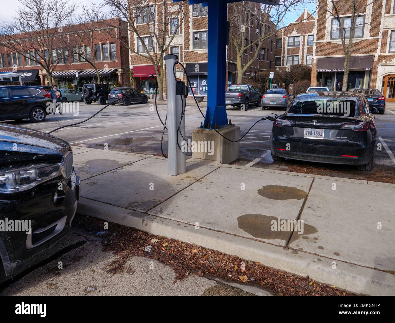 EV charging station with BMW  X5 plugin hybrid and Tesla Model 3 charging. Stock Photo