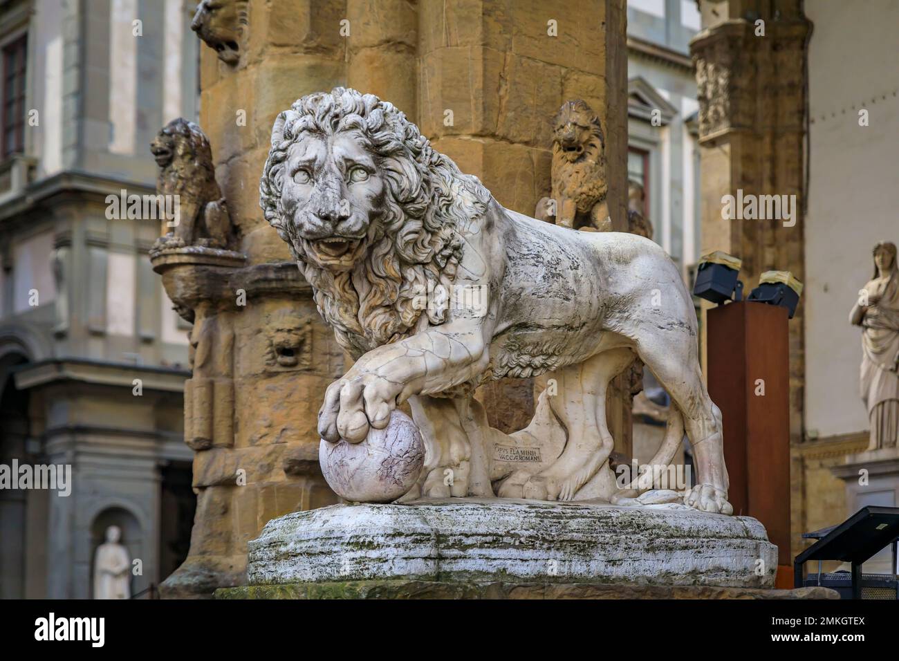 Statue of one of Medici lions in the Loggia dei Lanzi in front of Palazzo Vecchio on public Square of Signoria in Florence, Italy Stock Photo