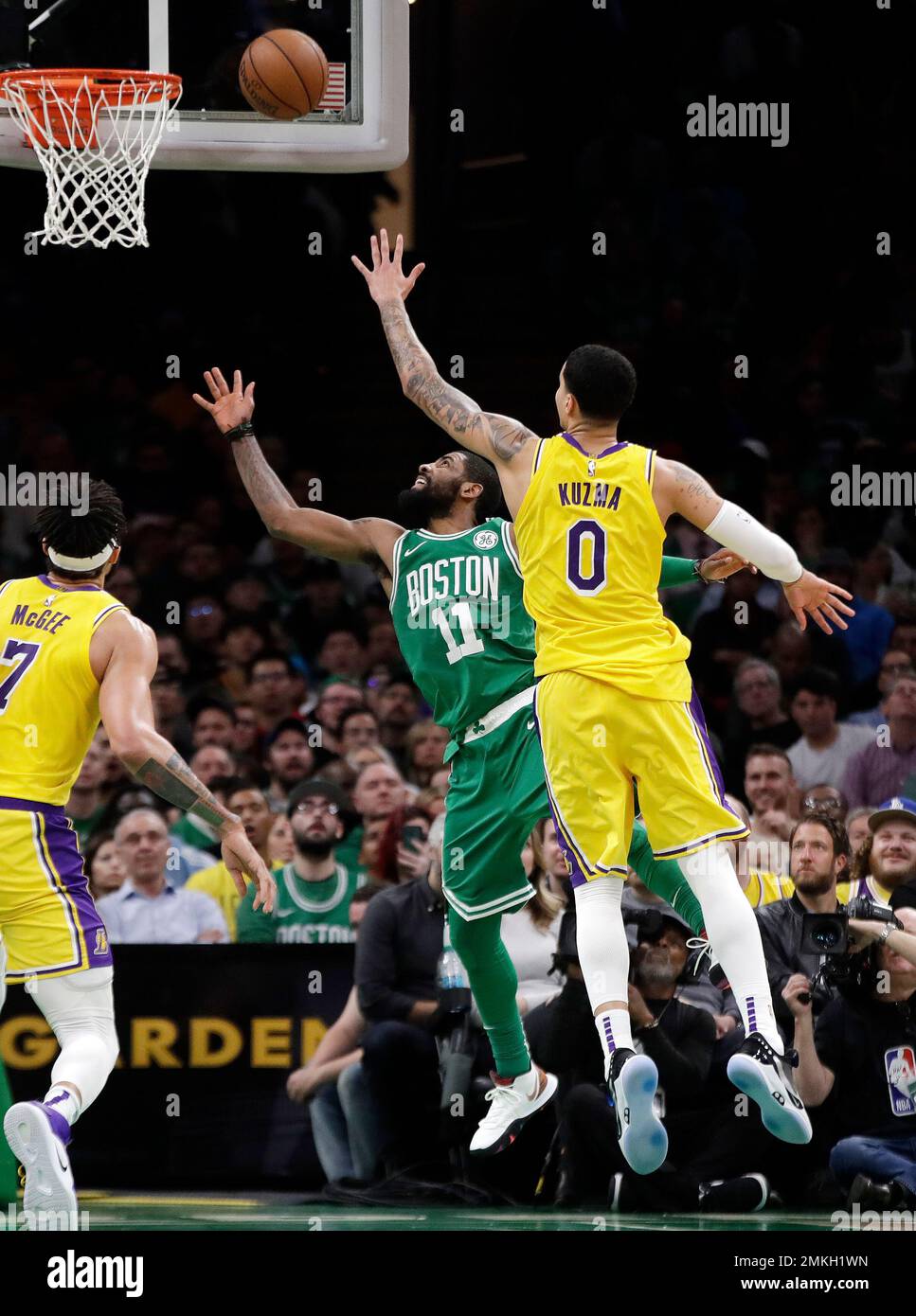 In this Feb. 7, 2019, photo, Los Angeles Lakers forward Kyle Kuzma (0)  defends against Boston Celtics guard Kyrie Irving (11) during an NBA  basketball game in Boston. Kuzma is wearing Nike's