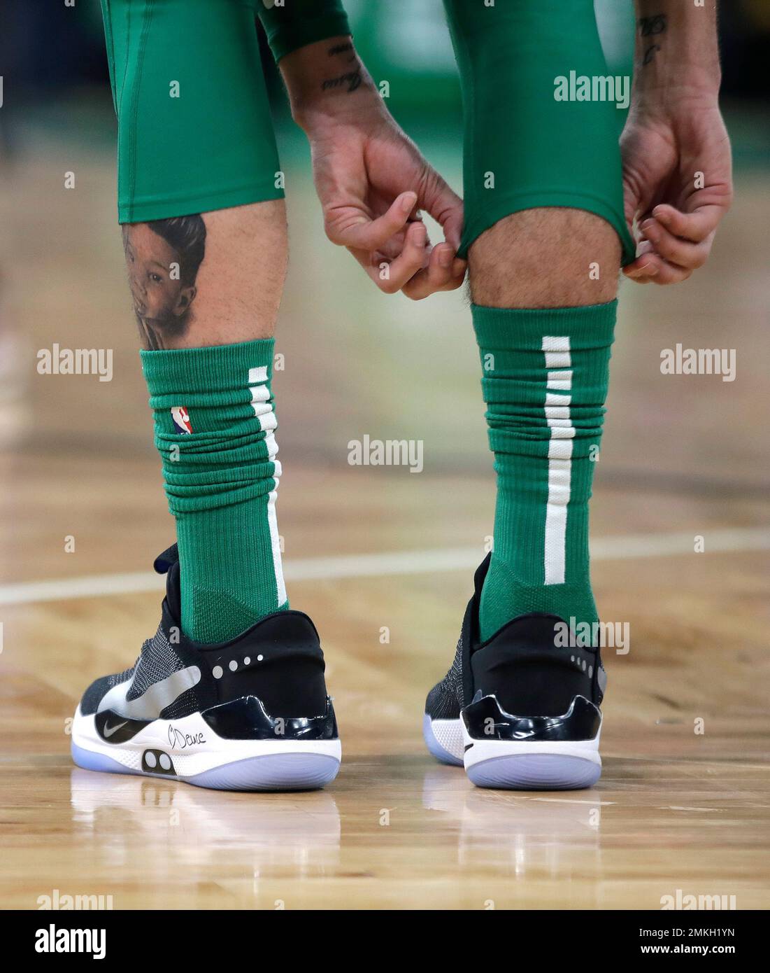In this Feb. 7, 2019, photo, Boston Celtics forward Jayson Tatum adjusts  his knee sleeve during an NBA basketball game against the Los Angeles  Lakers in Boston. He is wearing Nike's latest