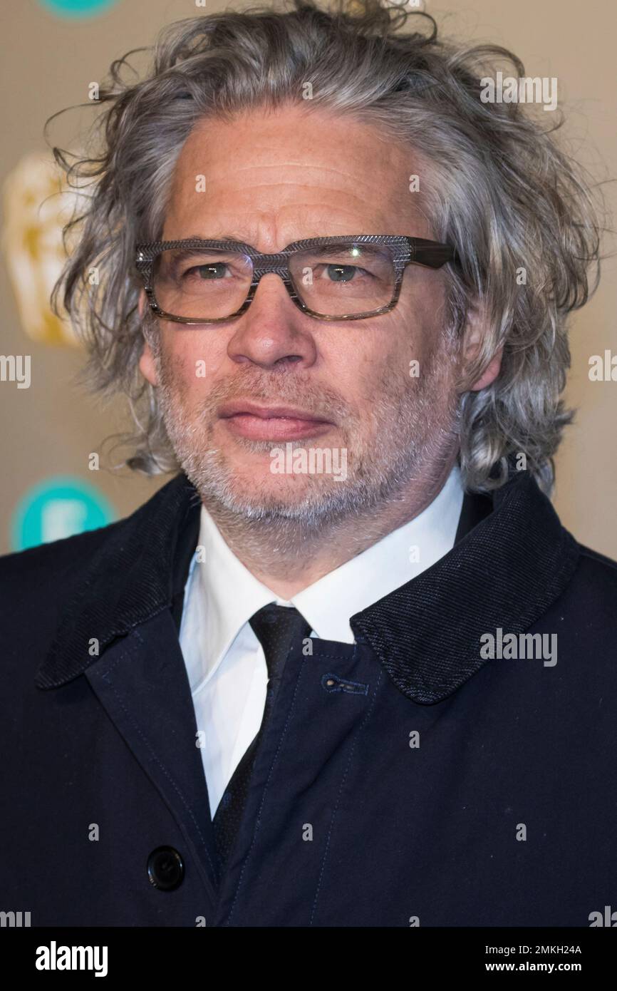 Dexter Fletcher poses for photographers upon arrival at the BAFTA Film