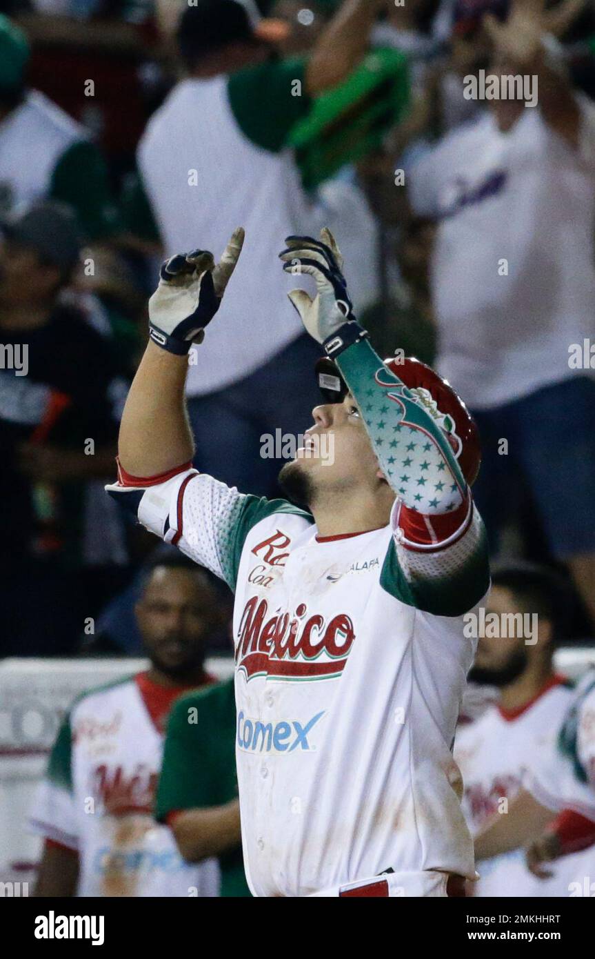 Victor Mendoza of Mexico's Los Charros de Jaliscos celebrates after scoring  against Venezuela's Cardenales de Lara in the sixth inning of a Caribbean  Series baseball tournament game at the Rod Carew stadium