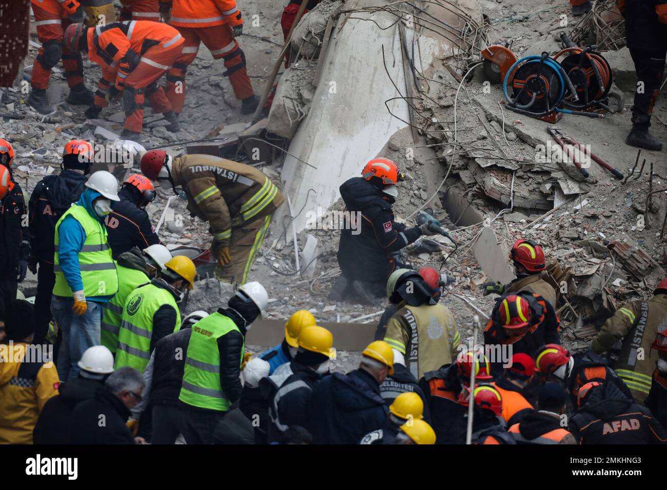 Rescue workers continue to remove rubble from an eight-story building ...
