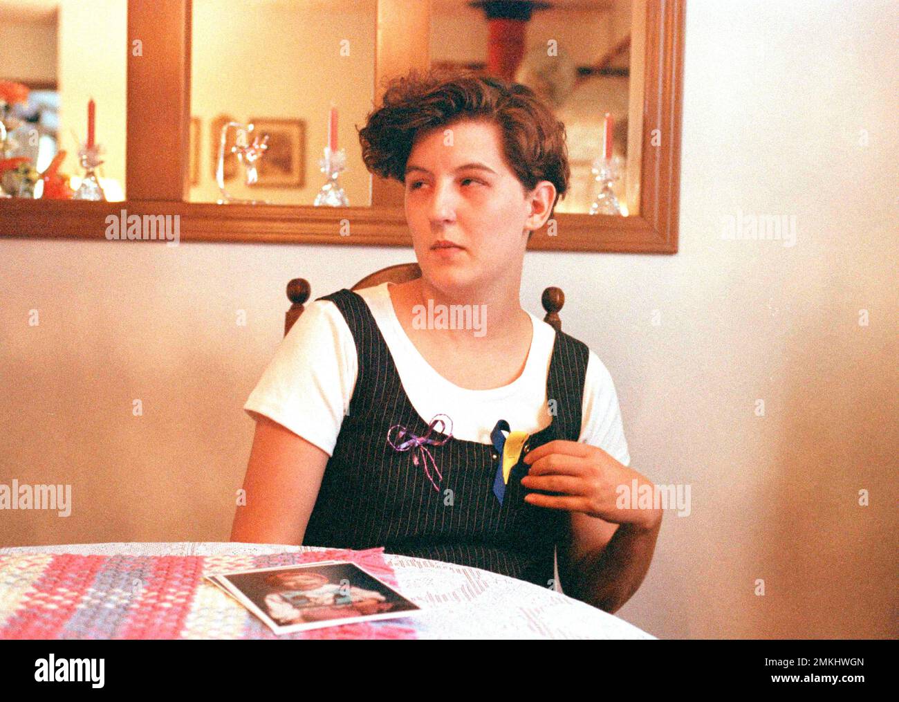 Aren Almon, pictured April 21, 1995, talks about her year-old daughter Baylee Almon, as she sits in the Oklahoma City home of her grandparents. The infant died as a result of the car bombing Wednesday at the Alfred P. Murrah Federal Building, and a photo showing her tiny body being handed off from policeman to firefighter has become a symbol of the horrific attack. (AP Photo/Pat Sullivan) Stock Photo