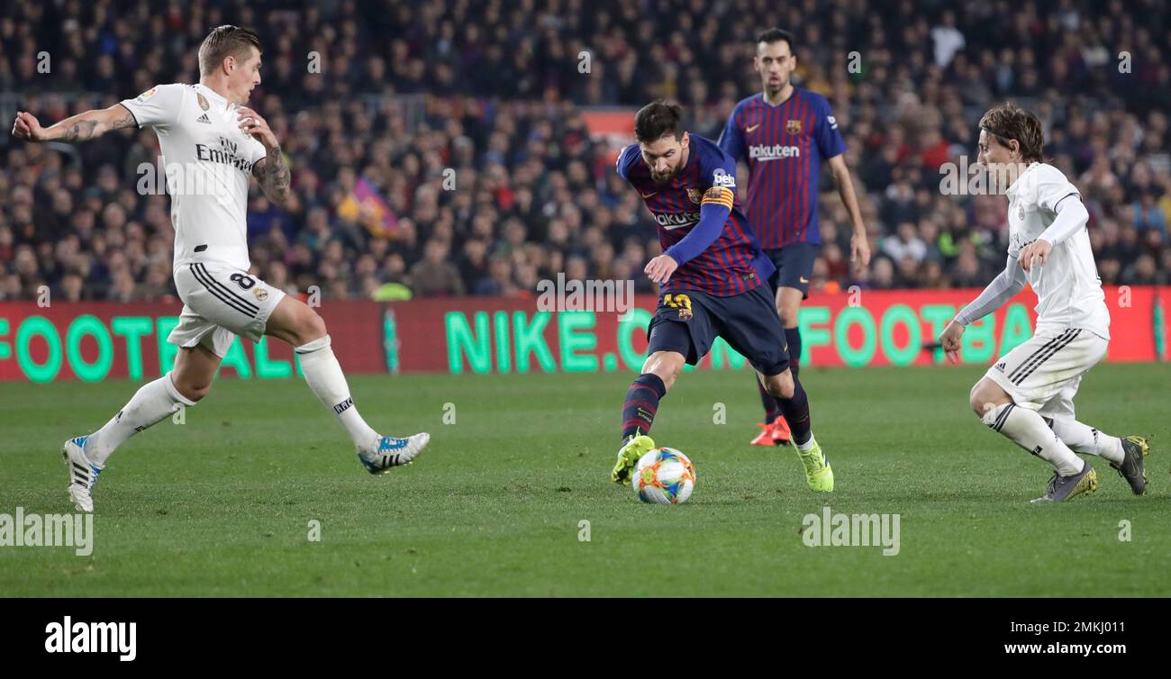 Real midfielder Toni Kroos, left, and Real midfielder Luka Modric, right,  run to stop Barcelona forward Lionel Messi, center, during the Copa del Rey  semifinal first leg soccer match between FC Barcelona